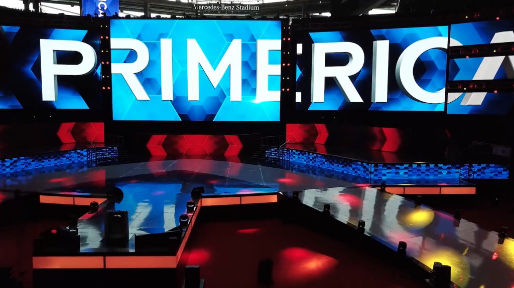 The stage at the Mercedes-Benz stadium during the Primerica International Convention with the word “Primerica” shown across multiple TV screens.