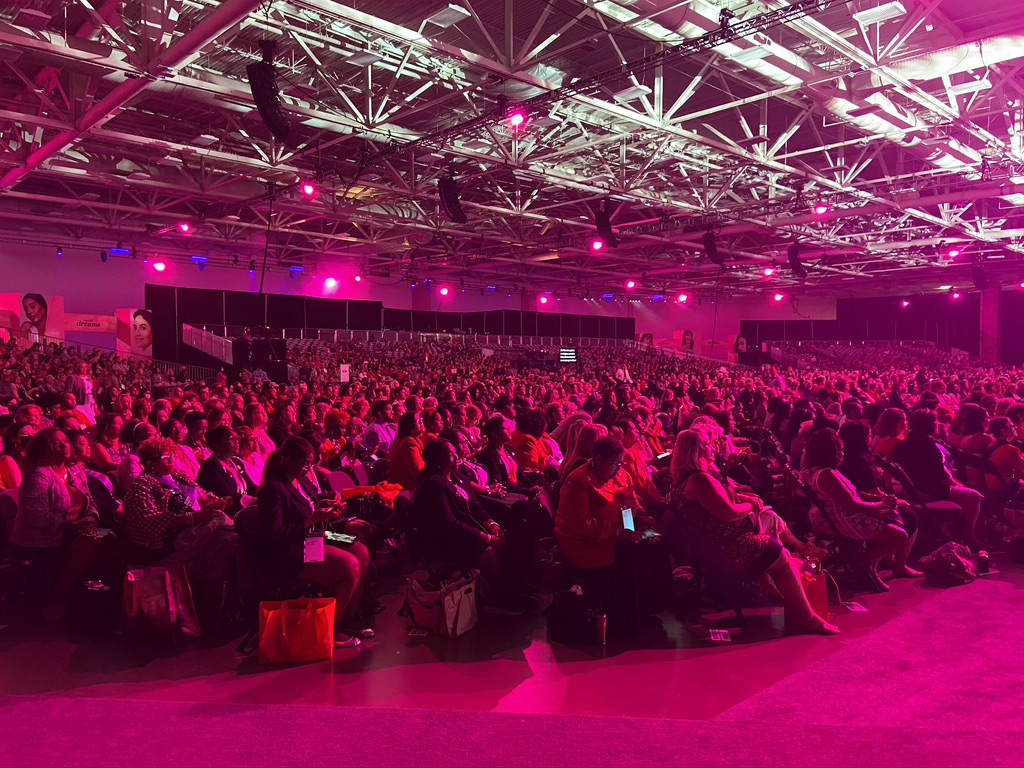 The stage at the Mercedes-Benz stadium during the Primerica International Convention with the word “Primerica” shown across multiple TV screens.