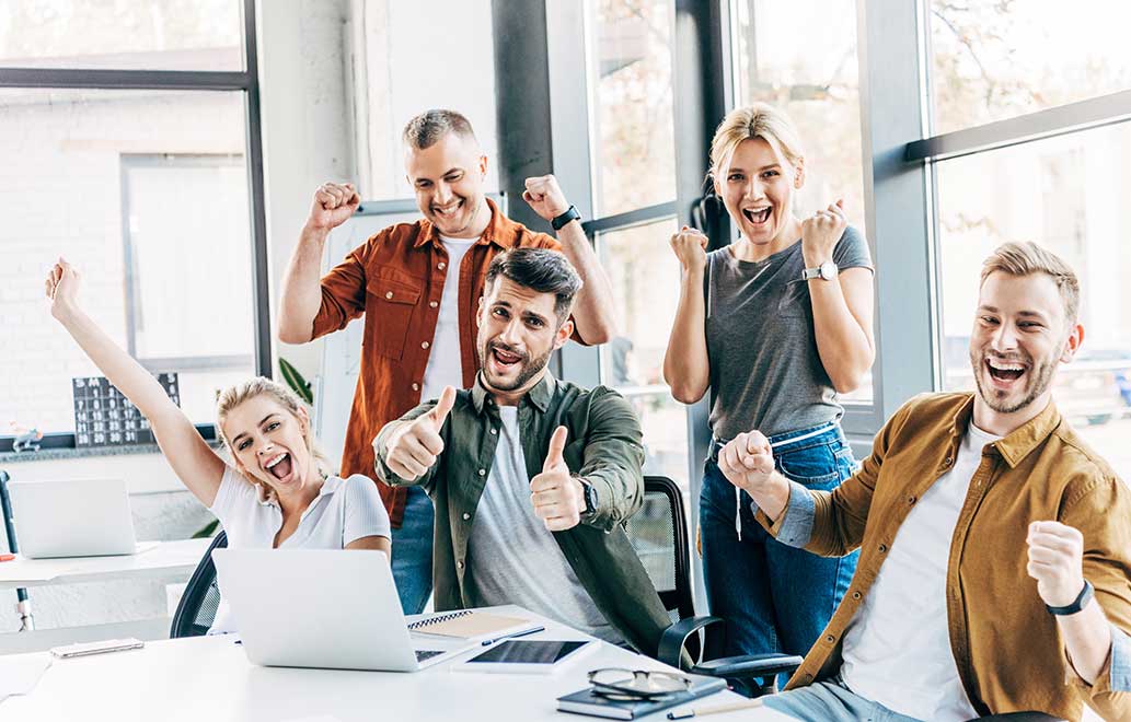 Group of happy successful entrepreneurs celebrating